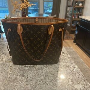 Louis Vuitton never full. Includes wallet. 100% authentic.